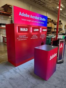 Custom Exhibit with LED Halo and Backlit Lights, SuperNova Header Lightbox, Lighting Remote, SYM-416 Counter with Fabric Graphics, and MOD-1549 Lectern with Graphics -- View 2